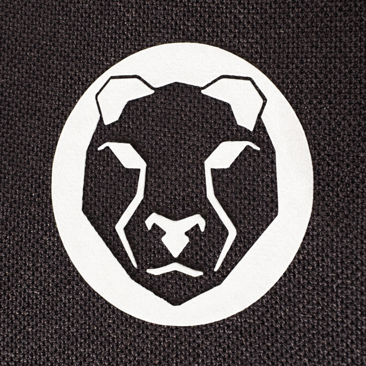 Close-up of Mammal Strength logo printed on black neoprene fabric used in V3 5mm elbow sleeves